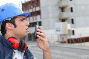 10855204 Man speaking into a walkie talkie Stock Photo radio